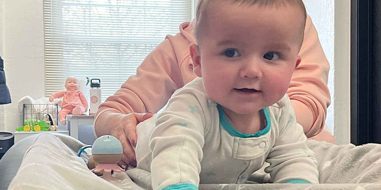 Baby chiropractor performing tummy time alternative on baby