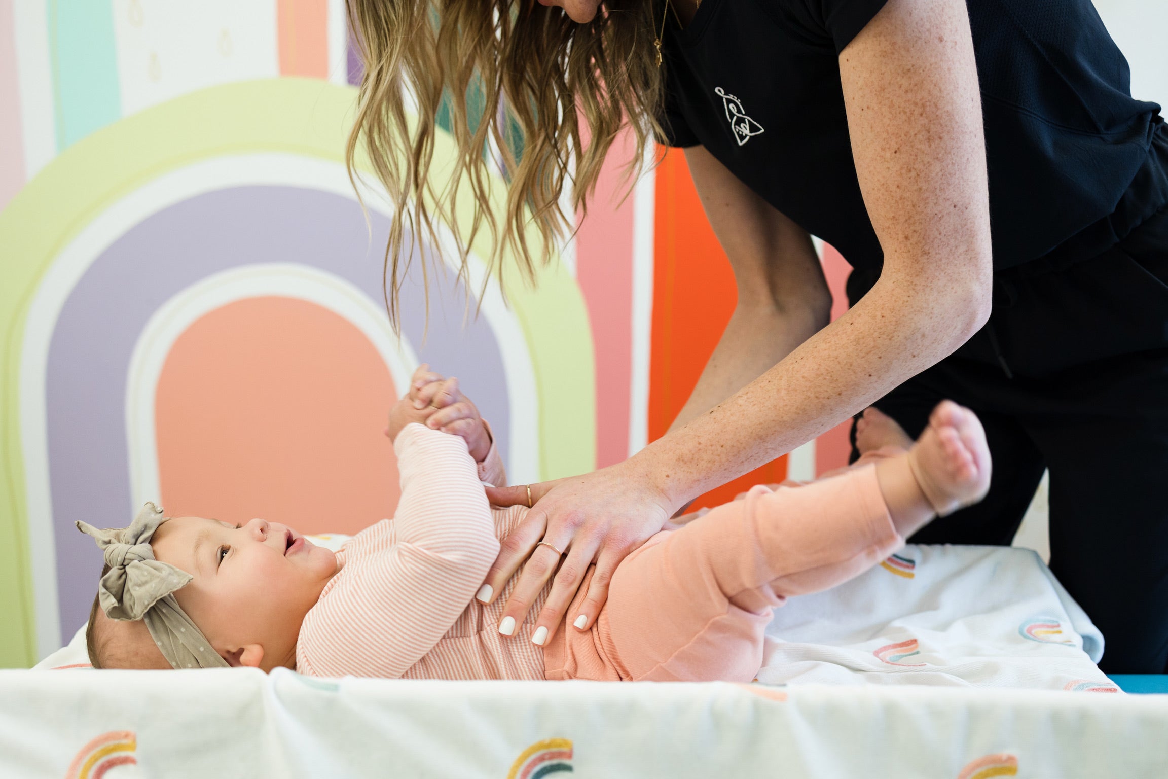 Baby chiropractor performs a diaphragm massage to relieve tension for colicky baby