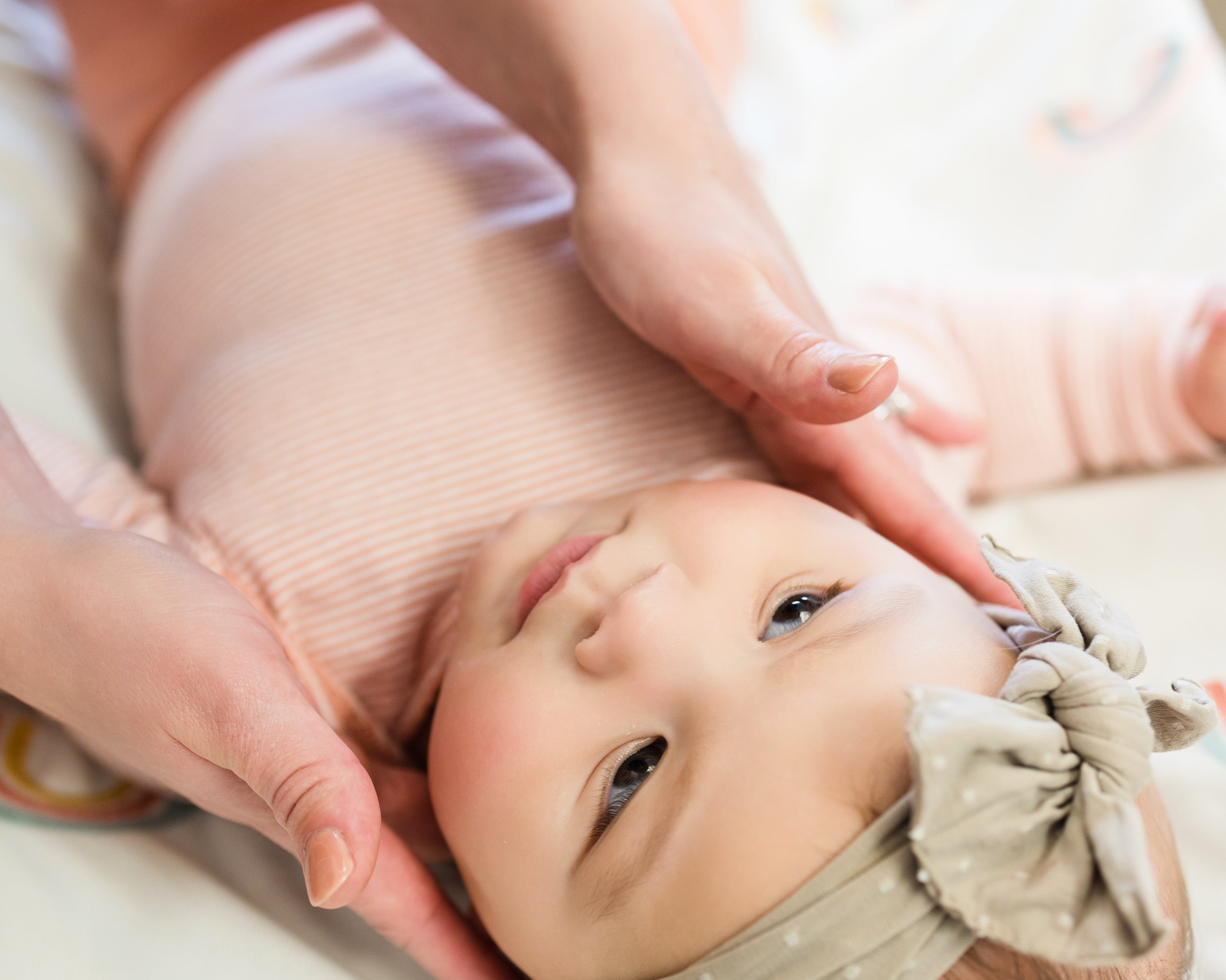 Baby chiropractor performing infant craniosacral therapy