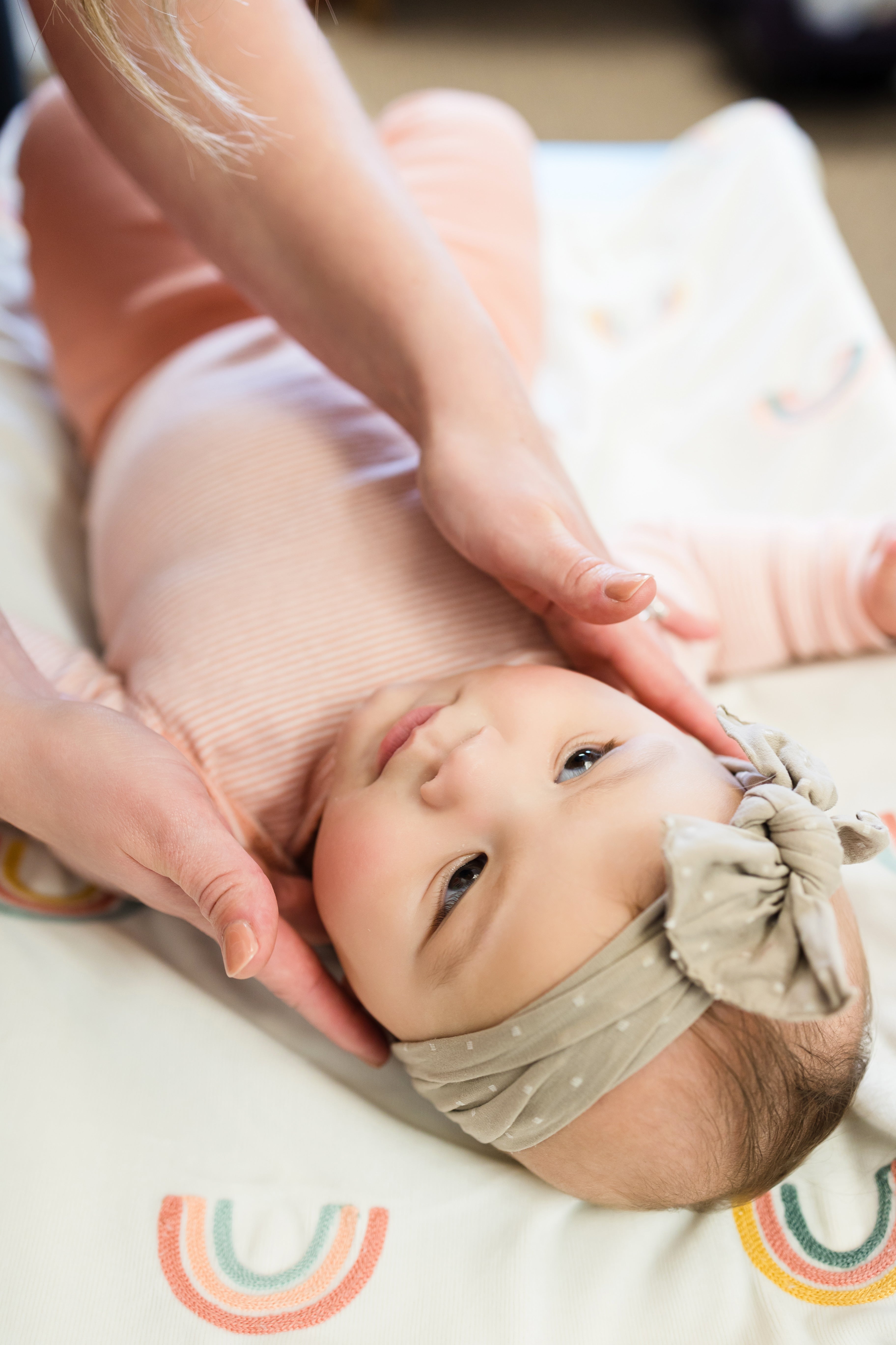 Baby chiropractor performing infant craniosacral therapy