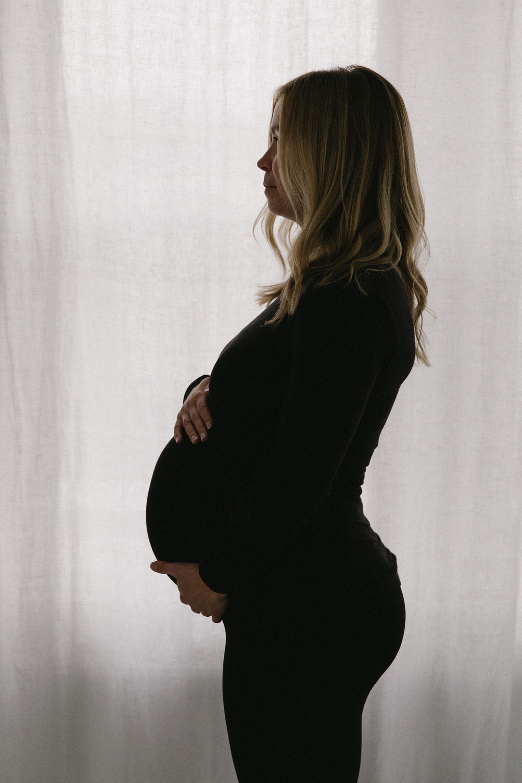 Pregnant woman holding belly webster 