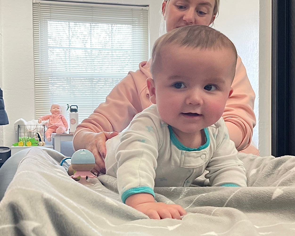 Baby chiropractor performing tummy time alternative on baby