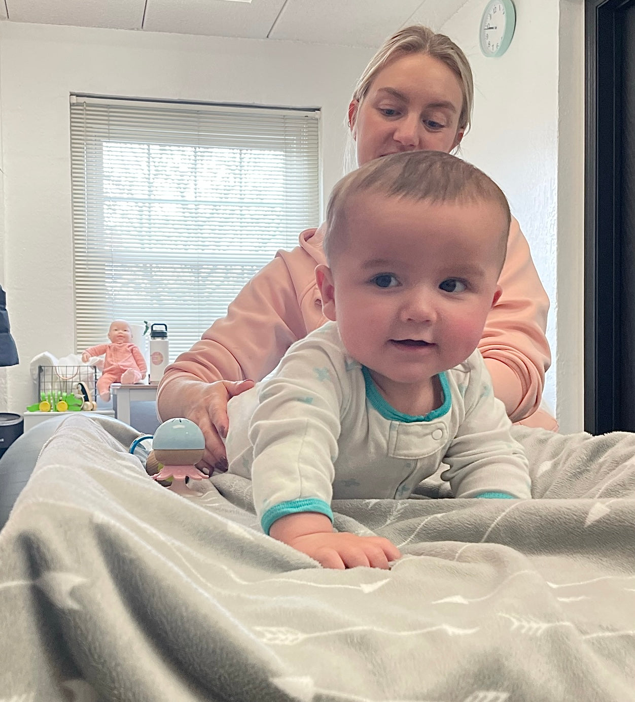 Baby chiropractor performing tummy time alternative on baby