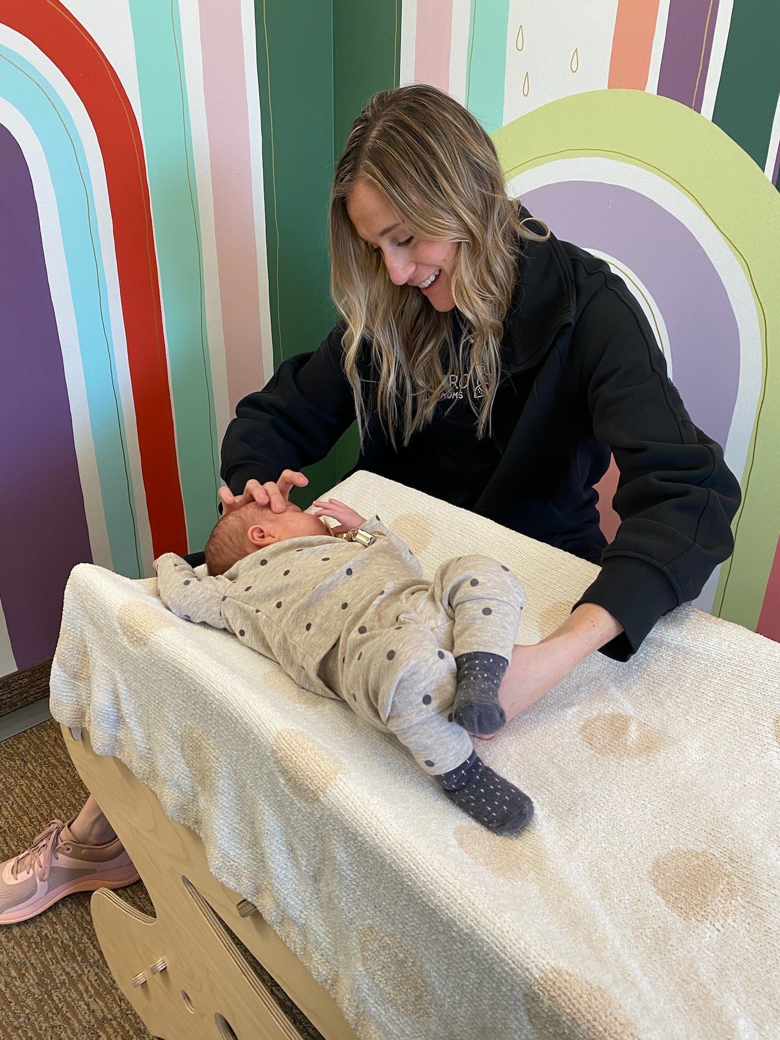 Baby chiropractor performing infant craniosacral therapy